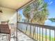 This balcony features a view of the adjacent river, chairs and a table at 6317 Newtown Cir # 17B2, Tampa, FL 33615