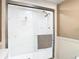 Bathroom featuring a white shower with glass doors and modern fixtures at 6317 Newtown Cir # 17B2, Tampa, FL 33615
