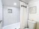 Bright bathroom featuring a shower with white tile, stylish curtain, and modern fixtures at 6317 Newtown Cir # 17B2, Tampa, FL 33615