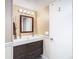 Bathroom featuring a modern sink, mirror, decorative lighting, and white wainscotting at 6317 Newtown Cir # 17B2, Tampa, FL 33615