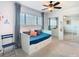 Bedroom featuring a daybed with trundle, ceiling fan, large window, and mirrored closet doors at 6317 Newtown Cir # 17B2, Tampa, FL 33615