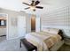 Cozy bedroom featuring ceiling fan, stylish accent wall, and carpeted flooring at 6317 Newtown Cir # 17B2, Tampa, FL 33615