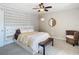 Well-lit bedroom featuring a ceiling fan, carpeted flooring, and decorative accent wall at 6317 Newtown Cir # 17B2, Tampa, FL 33615