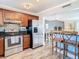 Modern kitchen with breakfast bar and stainless steel appliances at 6317 Newtown Cir # 17B2, Tampa, FL 33615