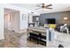 Open-concept living room with stylish gray accent wall, piano, and inviting dining area at 6317 Newtown Cir # 17B2, Tampa, FL 33615