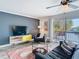 Relax in this living room complete with dark walls, white accents and a large sliding glass door at 6317 Newtown Cir # 17B2, Tampa, FL 33615