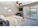 Serene main bedroom with balcony access, ceiling fan, and cozy seating area at 6317 Newtown Cir # 17B2, Tampa, FL 33615