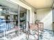 Enjoy this patio featuring chairs, a table and a view into the living room at 6317 Newtown Cir # 17B2, Tampa, FL 33615