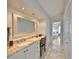 Bright bathroom featuring dual sinks, granite countertop, and walk-in shower with updated fixtures at 6467 Rubia Cir, Apollo Beach, FL 33572