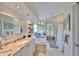 Elegant bathroom with a soaking tub, granite countertops, and ample natural light at 6467 Rubia Cir, Apollo Beach, FL 33572
