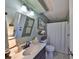 Bright bathroom featuring a large mirror, a single sink, and a shower with updated fixtures at 6467 Rubia Cir, Apollo Beach, FL 33572