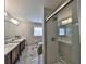 Well-lit bathroom featuring a double vanity, a shower, and modern fixtures at 6467 Rubia Cir, Apollo Beach, FL 33572