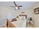 Cozy bedroom features wood floors, a queen bed, a ceiling fan, and ample natural light at 6467 Rubia Cir, Apollo Beach, FL 33572