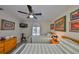 This bedroom boasts twin beds, modern decor, and a ceiling fan for comfortable living at 6467 Rubia Cir, Apollo Beach, FL 33572