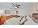 Serene bedroom with a comfortable bed, ceiling fan, and ample closet space at 6467 Rubia Cir, Apollo Beach, FL 33572
