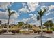 Front view of the community entrance featuring palm trees, shrubs and a water fountain at 6467 Rubia Cir, Apollo Beach, FL 33572