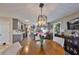 Inviting dining area with a wooden table, elegant lighting, and open access to the contemporary kitchen at 6467 Rubia Cir, Apollo Beach, FL 33572