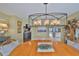 A stylish dining room offers an elegant wood table and chairs under a distinctive modern light fixture at 6467 Rubia Cir, Apollo Beach, FL 33572