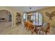 Dining room with a large wooden table, ample seating, and decorative accents at 6467 Rubia Cir, Apollo Beach, FL 33572