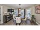 Cozy dining room features a wooden table, modern chandelier, and natural light at 6467 Rubia Cir, Apollo Beach, FL 33572