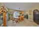 This dining room features a beautiful oval table, unique light fixture, and a lovely arched window at 6467 Rubia Cir, Apollo Beach, FL 33572