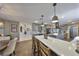 Open kitchen and dining area featuring gray cabinetry, quartz countertops, and stainless steel appliances at 6467 Rubia Cir, Apollo Beach, FL 33572