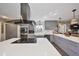 An open kitchen featuring gray cabinets, stainless steel appliances, and a stylish island with bar seating at 6467 Rubia Cir, Apollo Beach, FL 33572
