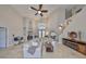 Elegant living room featuring travertine floors, high ceilings, and a cozy fireplace for relaxation at 6467 Rubia Cir, Apollo Beach, FL 33572