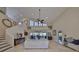 Bright living room showcasing vaulted ceilings, a ceiling fan, and sliding glass doors at 6467 Rubia Cir, Apollo Beach, FL 33572