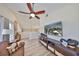 Inviting living room with wood-look floors, TV, ceiling fan and lots of natural light at 6467 Rubia Cir, Apollo Beach, FL 33572