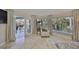 Bright living room with tile floors, serene pool view, and comfortable seating area at 6467 Rubia Cir, Apollo Beach, FL 33572