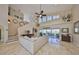 Bright, open living room with high ceilings, travertine floors, and views of the outdoor patio at 6467 Rubia Cir, Apollo Beach, FL 33572