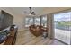 Bright living room with wood floors, comfortable seating, and sliding doors to the outside at 6467 Rubia Cir, Apollo Beach, FL 33572