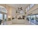 A grand living room with soaring ceilings, travertine floors, and elegant decor provides a luxurious space at 6467 Rubia Cir, Apollo Beach, FL 33572