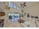 Spacious living room with abundant natural light, travertine floors, and a view of the pool area at 6467 Rubia Cir, Apollo Beach, FL 33572