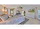 Spacious main bedroom suite featuring a large bed, ceiling fan, and access to the outdoors at 6467 Rubia Cir, Apollo Beach, FL 33572