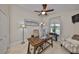 Office with a wood desk, arched window letting in natural light, and a comfortable sitting area at 6467 Rubia Cir, Apollo Beach, FL 33572