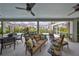 Relaxing screened-in patio with comfortable seating overlooking the pool and lush landscaping at 6467 Rubia Cir, Apollo Beach, FL 33572
