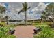 Scenic view of a community pond with a fountain, surrounded by well-maintained landscaping and benches at 6467 Rubia Cir, Apollo Beach, FL 33572