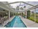 A long, rectangular pool is surrounded by an outdoor living space with ample seating at 6467 Rubia Cir, Apollo Beach, FL 33572