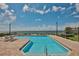 Community pool offers stunning ocean views, surrounded by brick pavers and lush landscaping at 6467 Rubia Cir, Apollo Beach, FL 33572