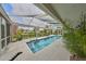 In-ground pool with covered patio, outdoor furniture, and landscaping offering a private retreat at 6467 Rubia Cir, Apollo Beach, FL 33572