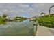 Scenic view of canal homes with private boat docks and lifts, on a sunny, partly cloudy day at 6467 Rubia Cir, Apollo Beach, FL 33572
