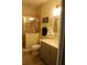 Tiled bathroom featuring a glass enclosed shower, vanity with storage and neutral paint at 6513 Sand Shore Ln, New Port Richey, FL 34652