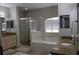 Bathroom featuring a soaking tub, a separate glass-enclosed shower, and dual vanities with granite countertops at 6513 Sand Shore Ln, New Port Richey, FL 34652
