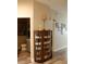 Hallway with decorative display cabinet and view to a guest bathroom at 6513 Sand Shore Ln, New Port Richey, FL 34652
