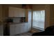 Bright kitchen with white cabinets, granite countertops, stainless steel appliances and a window for natural light at 6513 Sand Shore Ln, New Port Richey, FL 34652