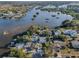 Aerial view of waterfront property with serene lake and lush greenery at 7 Georgia Ave, Crystal Beach, FL 34681