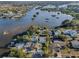 Aerial view of waterfront property with home surrounded by lush greenery and water access at 7 Georgia Ave, Crystal Beach, FL 34681