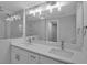Modern bathroom featuring double sinks, sleek white cabinets, and a spacious walk-in shower at 7 Georgia Ave, Crystal Beach, FL 34681
